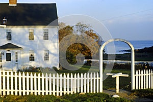 East coast home surrounded by white picket fence, ME
