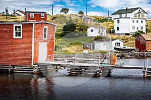 East coast homes and fishing tackle shacks on old wooden docks overlooking Trinity Bay Newfoundland Canada