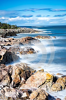 East Coast Long Exposure coastal picture with crashing waves on rocky headlands in Newfoundland and Labrador Canada photo