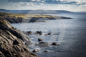 East Coast scene of rocky headlands with lone cabin overlooking the Atlantic Ocean at Cape Bonavista Newfoundland Canada