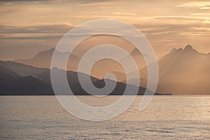 East Greenland coastal sunset - shades of yellow, orange and apricot