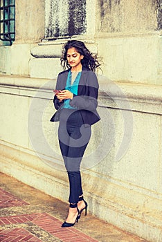 East Indian American college student texting outside in New York