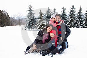 East Indian family playing in the snow