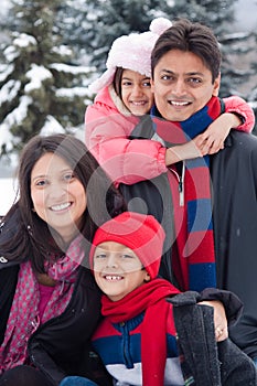 East Indian family playing in the snow