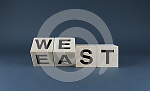 East vs west. Cubes form words east or west photo