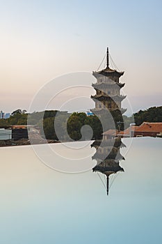 East and west towers of Kaiyuan Temple at dusk, with mirror reflection in foreground in Quanzhou