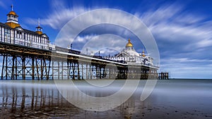Eastbourne Pier in East Sussex, England against a backdrop of long exposure clouds in the sky