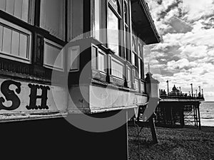 Eastbourne Pier monochrome fine art photo. Clouds over beach and sea.