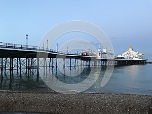 Eastbourne Pier over the sea under a blue sky in the evening in Eastbourne, England