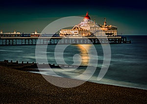 Eastbourne Pier surrounded by the sea with long exposure in the evening in England