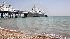 Eastbourne traditional English pier with beach and waves