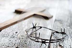 Easter abstract background with crown of thorns and cross on wooden planks