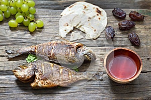 Easter ancient food with fish passover bread and goblet of wine last supper concept