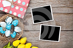 Easter background with blank photo frames, blue and white eggs,