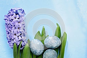 Easter background with blue eggs and spring flowers. Top view with copy space. Happy Easter Spring Festive greeting card. Holidays
