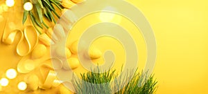 Easter background. Bright yellow eggs and bunch of spring blooming tulip flowers over yellow background