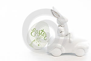 Easter background with a ceramic hare in the car.