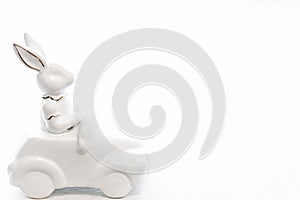 Easter background with a ceramic hare in the car.