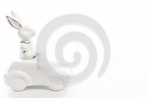 Easter background with a ceramic hare in the car.