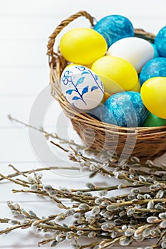 Easter background with colored eggs and catkins