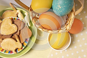 Easter background with colored eggs and homemade cookies