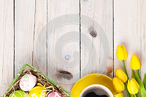 Easter background with colorful eggs and yellow tulips