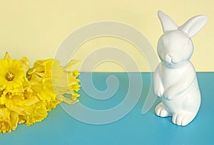 Easter background with Easter bunny and yellow daffodils