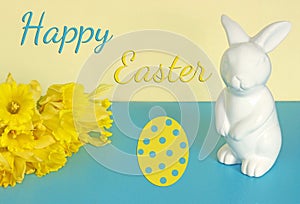 Easter background with Easter bunny, yellow daffodils and text