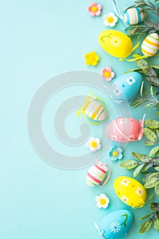 Easter background with Eggs, butterflies and spring flowers at blue.