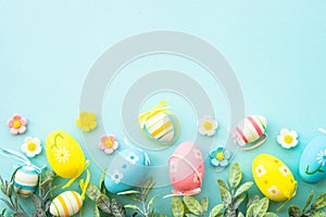 Easter background with Eggs, butterflies and spring flowers at blue.