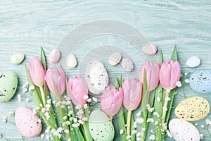Easter background from eggs and spring flowers. Top view. photo