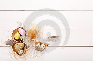 Easter background with Easter eggs and spring flowers. Top view with copy space