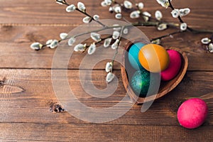 Easter background with Easter colorful eggs and spring flowers. Top view with copy space