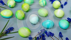 Easter background of green and blue eggs in harmony with the natural shades of flowers