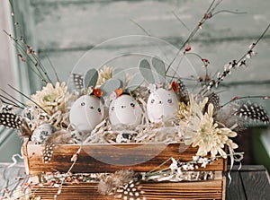 Easter background, homemade eggshell bunnies and yellow chrysanthemum in wooden box