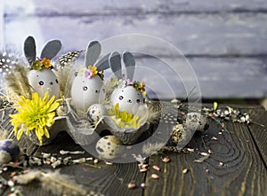 Easter background, homemade eggshells rabbits and yellow chrysanthemum in cardboard boxes