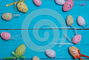 Easter background. Multicolored decorated easter eggs, multi-colored powder on a turquoise background. Free space