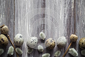 Easter background quail eggs catkins wooden table