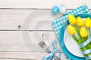 Easter background with yellow tulips and colorful eggs