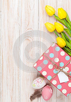 Easter background with yellow tulips and colorful eggs