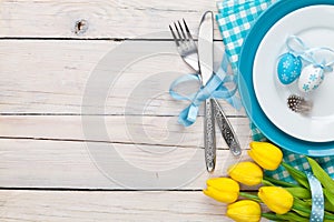 Easter background with yellow tulips and colorful eggs