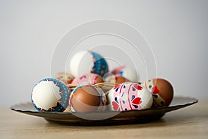 Easter basket with colorful Easter eggs on a wooden table