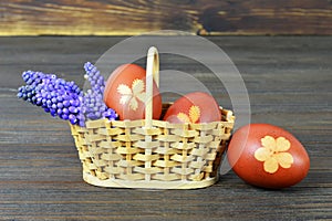 Easter basket. Easter eggs and spring flowers on wooden background