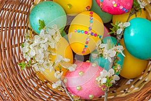 Easter basket with eggs close-up top view