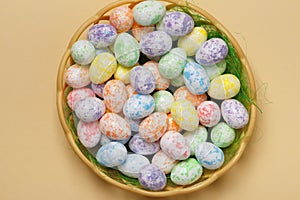 Easter basket with eggs on a yellow background close-up. top view