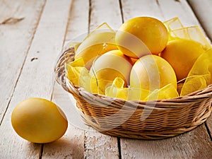 Easter basket full of Easter eggs coloured in yellow