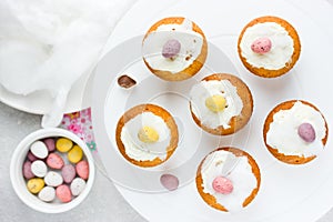 Easter birds nest cupcakes with chocolate candy eggs , whipped c