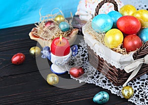 Easter bread and colorful eggs on a dark wooden background.