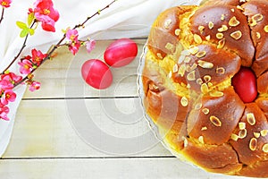 Easter bread, Easter eggs and a branch of flowering quince