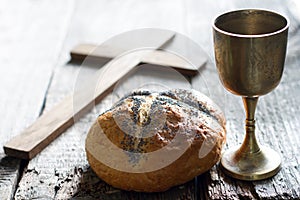 Easter bread wine and cross on vintage old wooden background